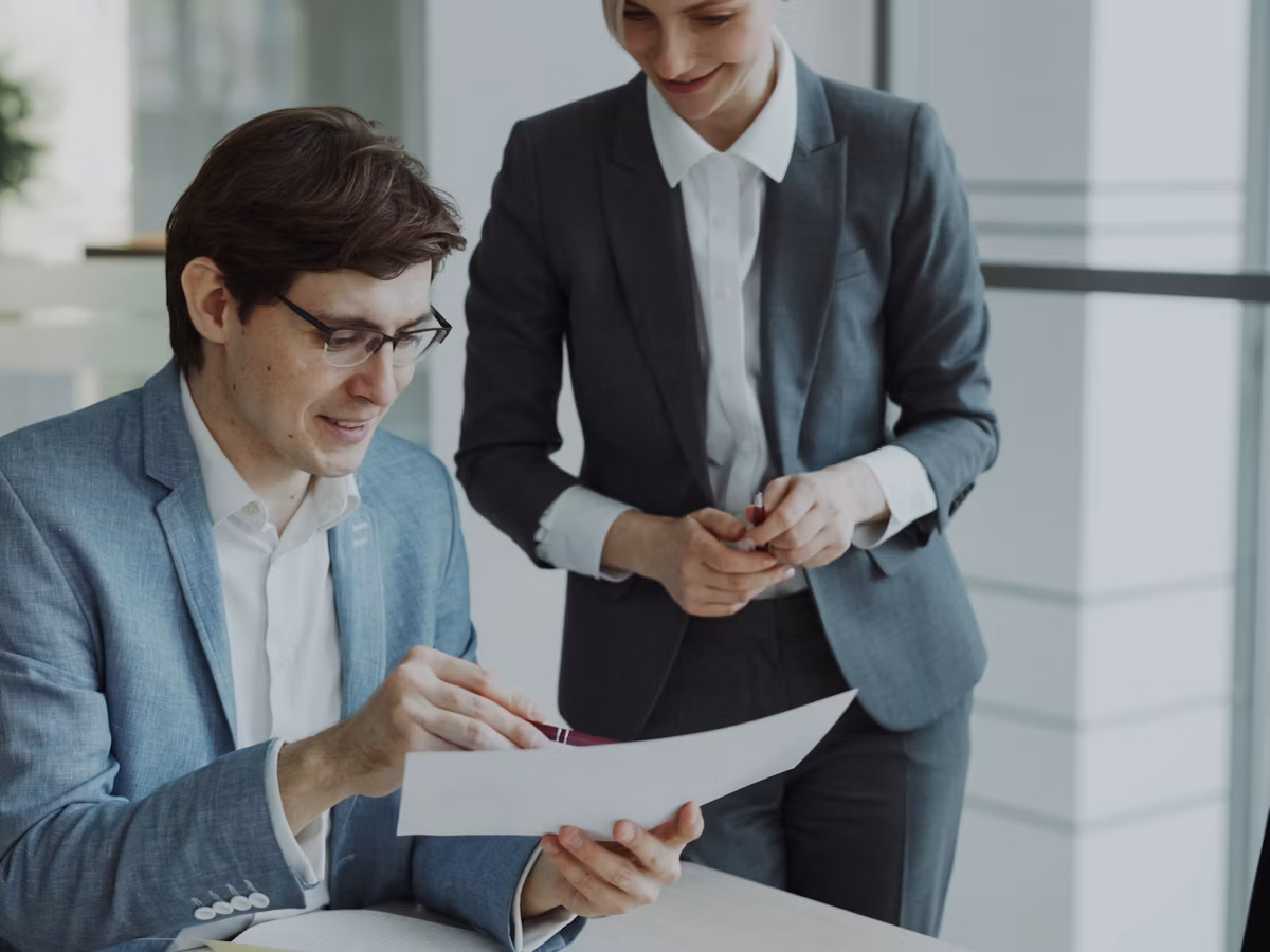 Compliance manager reviewing a contractor's records with a client at Gupta Consultant